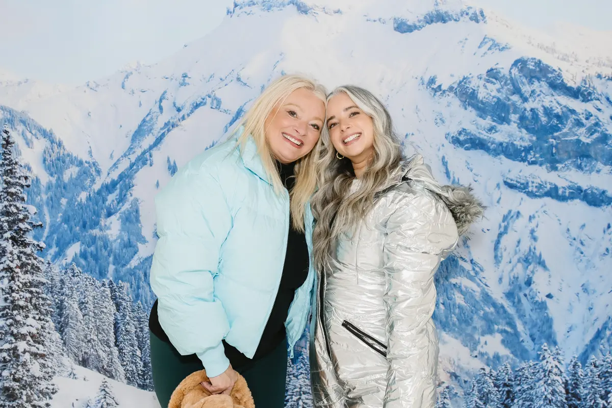 Friends at a winter mountain themed photo booth. A photo booth setup we bring to Reno events