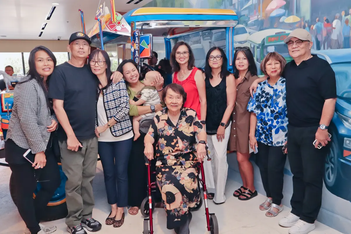 A multi-generational family gathered in front of the painted Jeepney display at the Angela Duldulao McPherson Museum and Philippine Cultural Arts Center grand opening in Port Hueneme CA, photographed by the Captured Celebrations roaming photographer