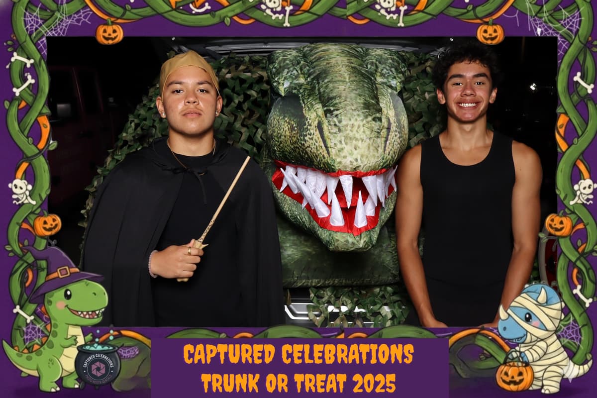 Captured Celebrations dinosaur-themed trunk display with free photo booth at Trunk or Treat 2025 community event