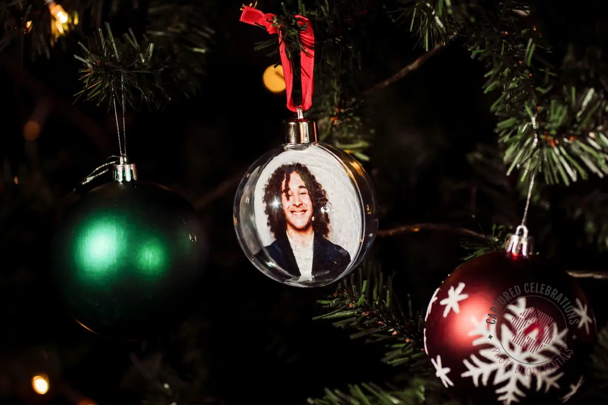 Photo ornaments from a Los Angeles company holiday party displayed on a tree