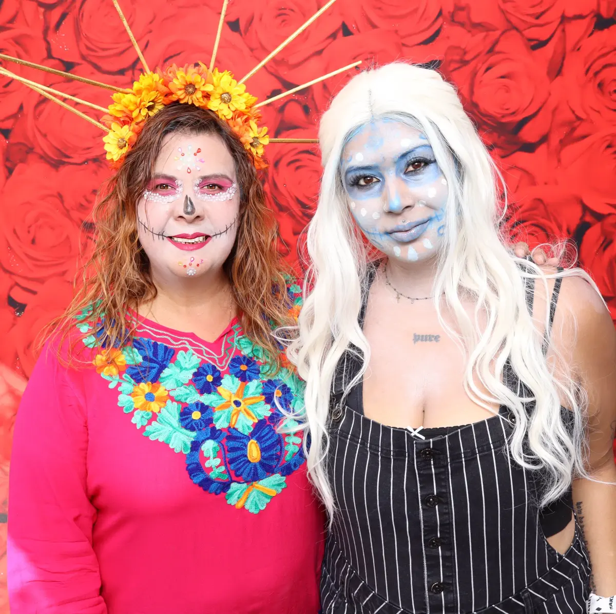 Two guests in Catrina face paint at the Canoga Park Día de los Muertos festival photo booth