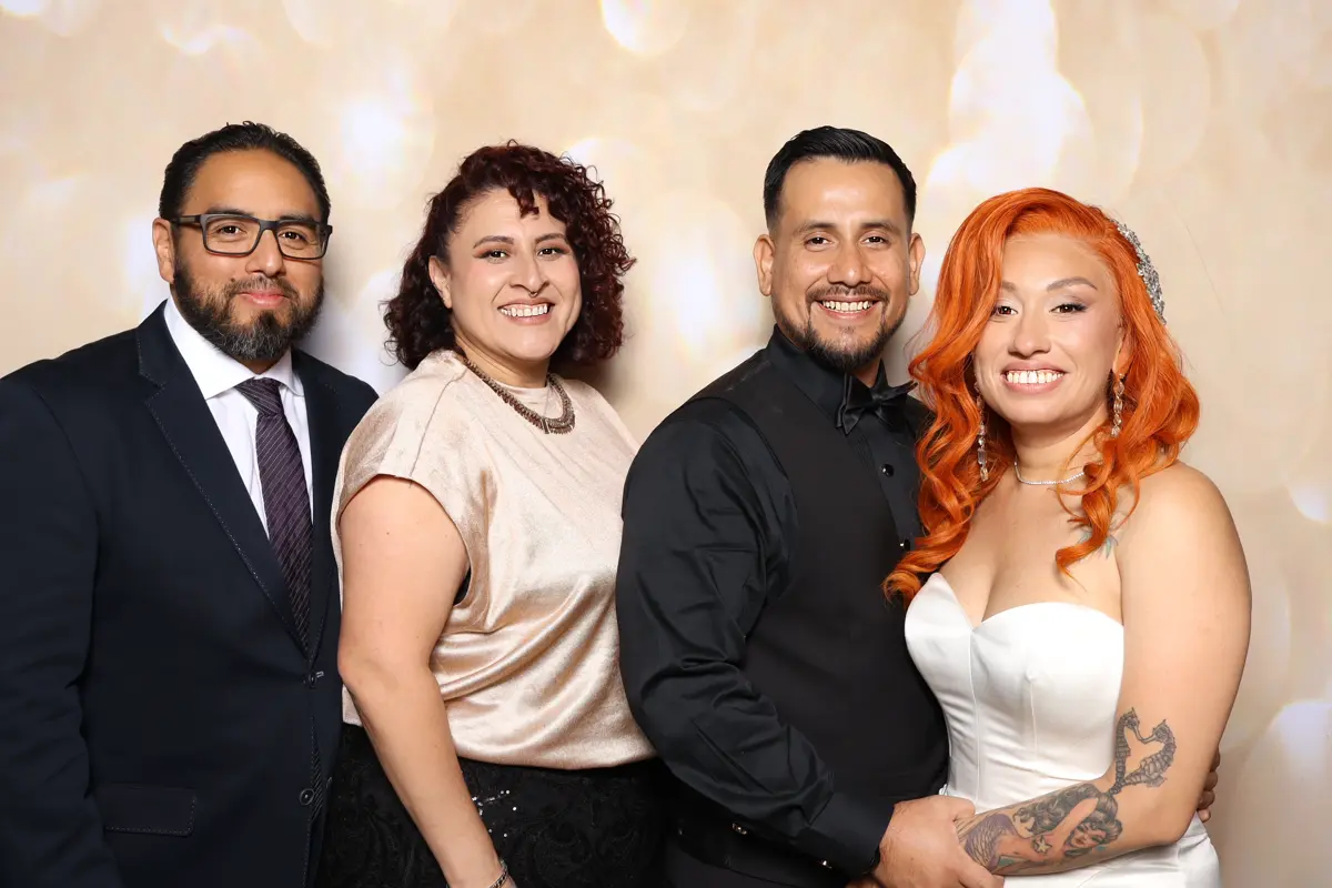 The bride and groom with two guests at the wedding photo booth at Hart & Main in Santa Clarita