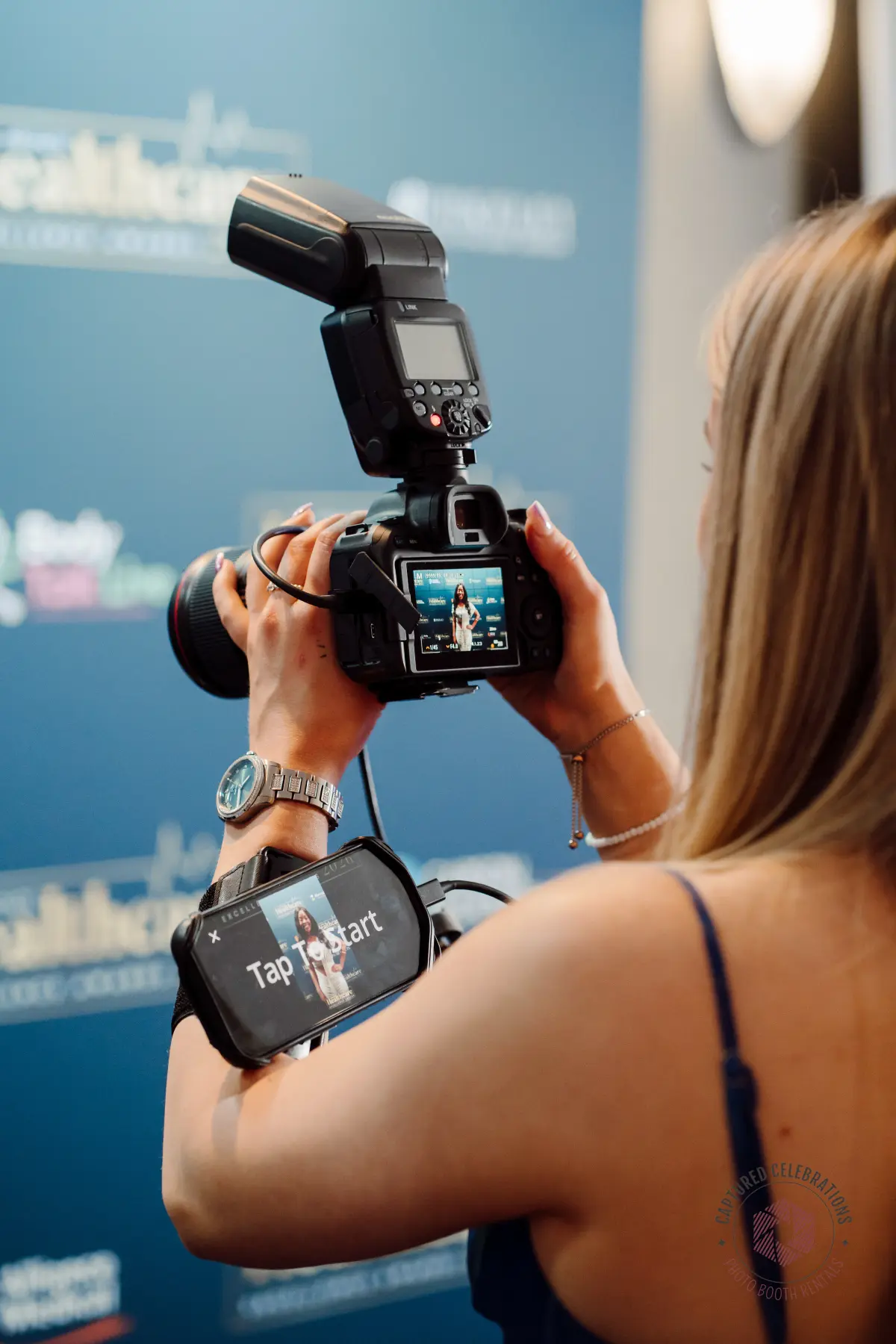 Roaming photographer with arm-mounted phone delivering branded photos at LA corporate event