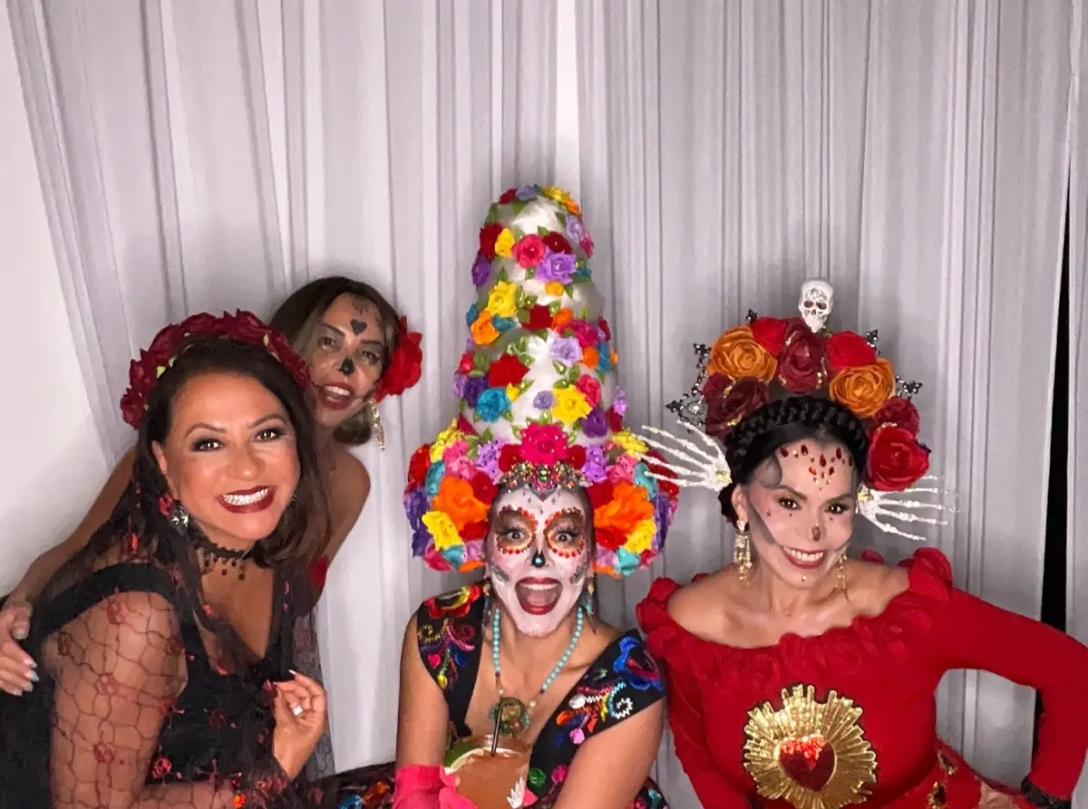 Four guests in Catrina costumes pose together at the Los Angeles Catrina Ball photo booth
