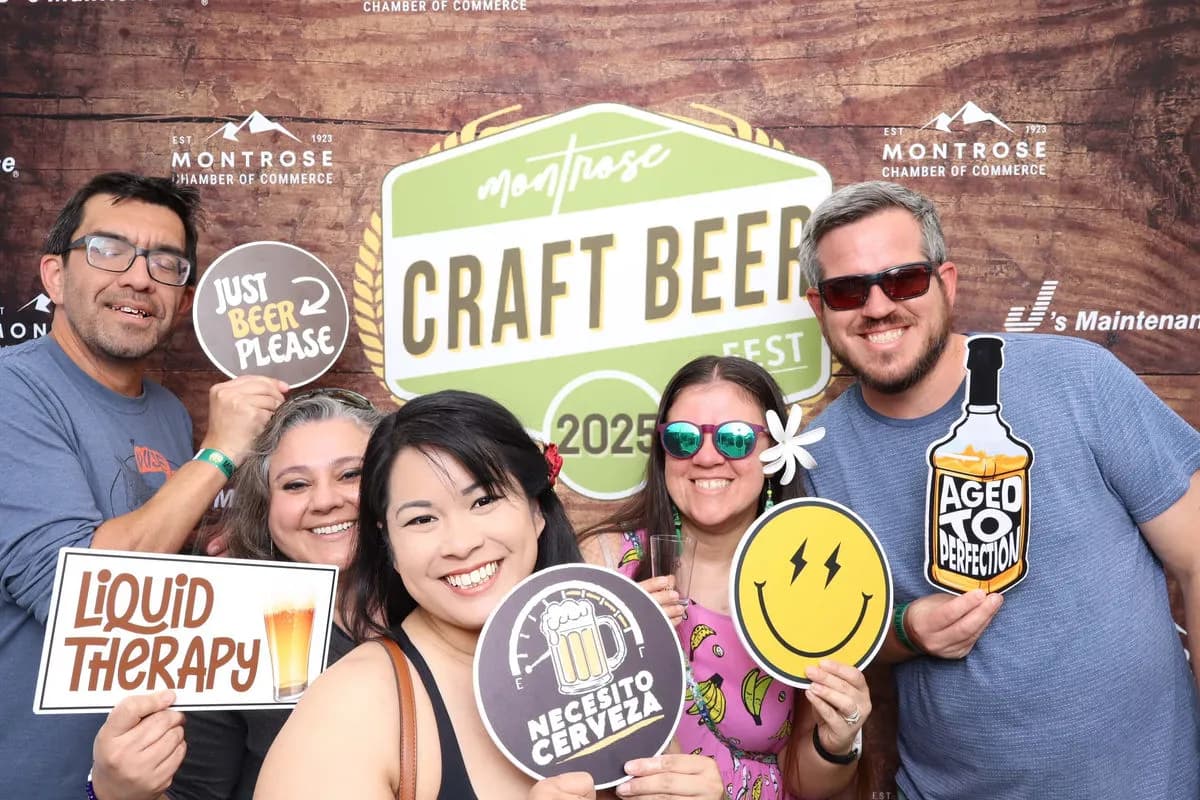 Groups of attendees posing with beer-themed props at Montrose Craft Beer Fest 2026