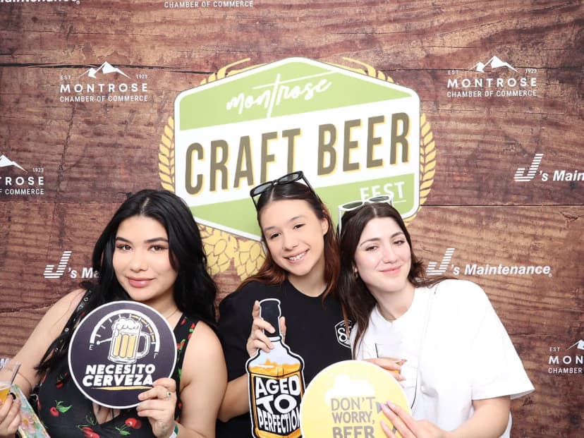 Craft beer enthusiasts at branded photo booth near Los Angeles at Montrose Beer Fest