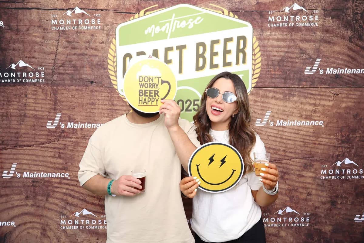 Step-and-repeat backdrop with multi-sponsor branding at Montrose Craft Beer Fest 2026