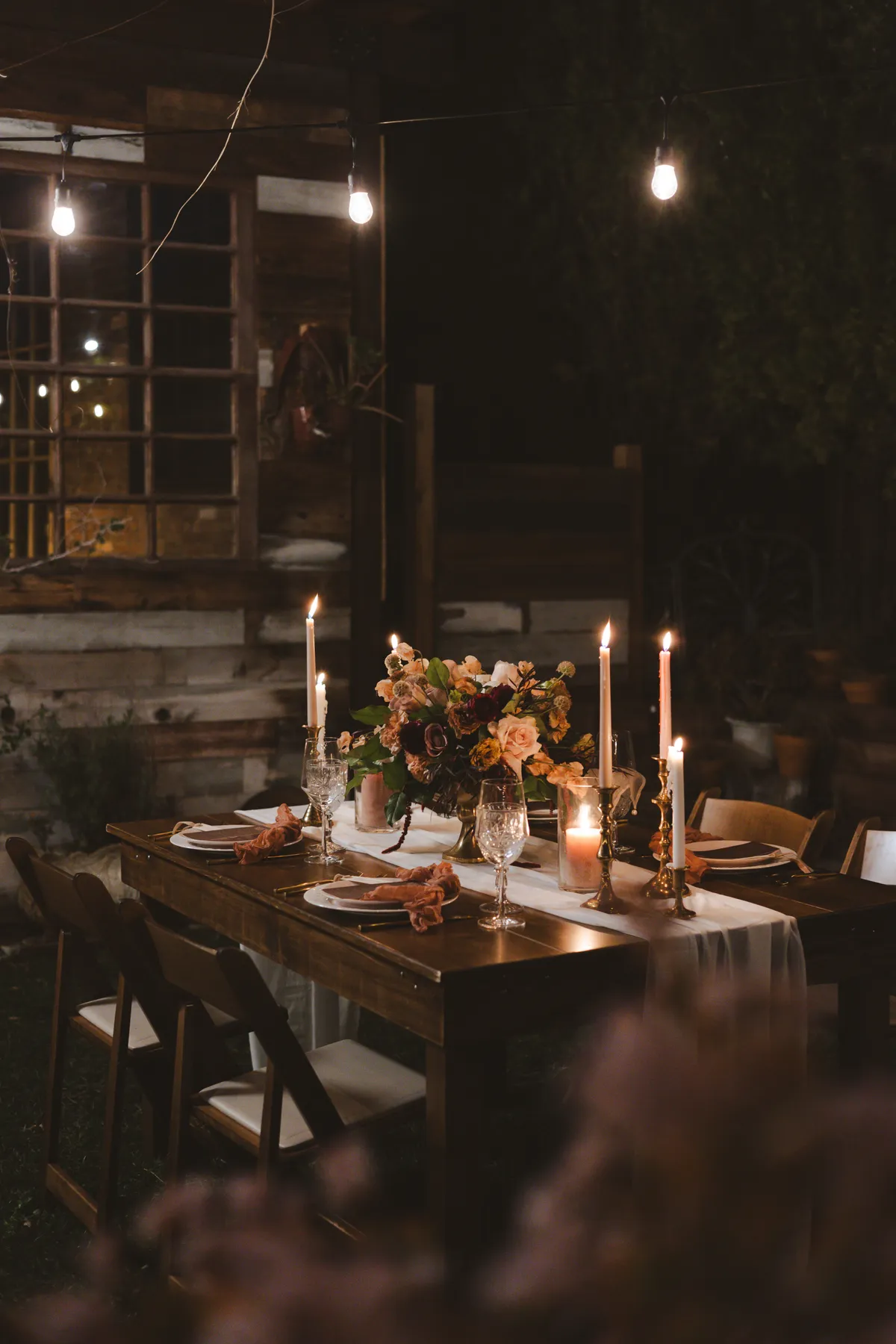 Boho Chic wedding table decorated with glassware, flowers and candles