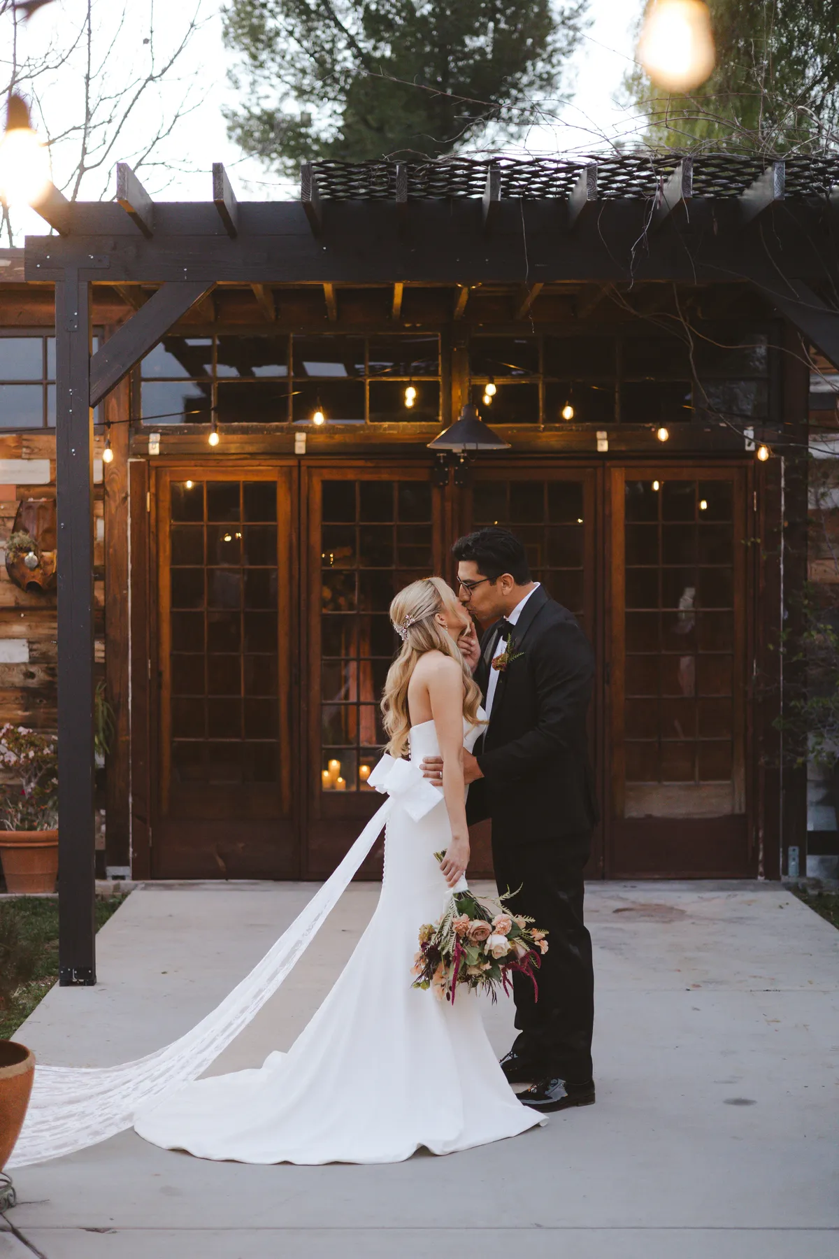 Boho Chic bride and groom sharing a kiss 