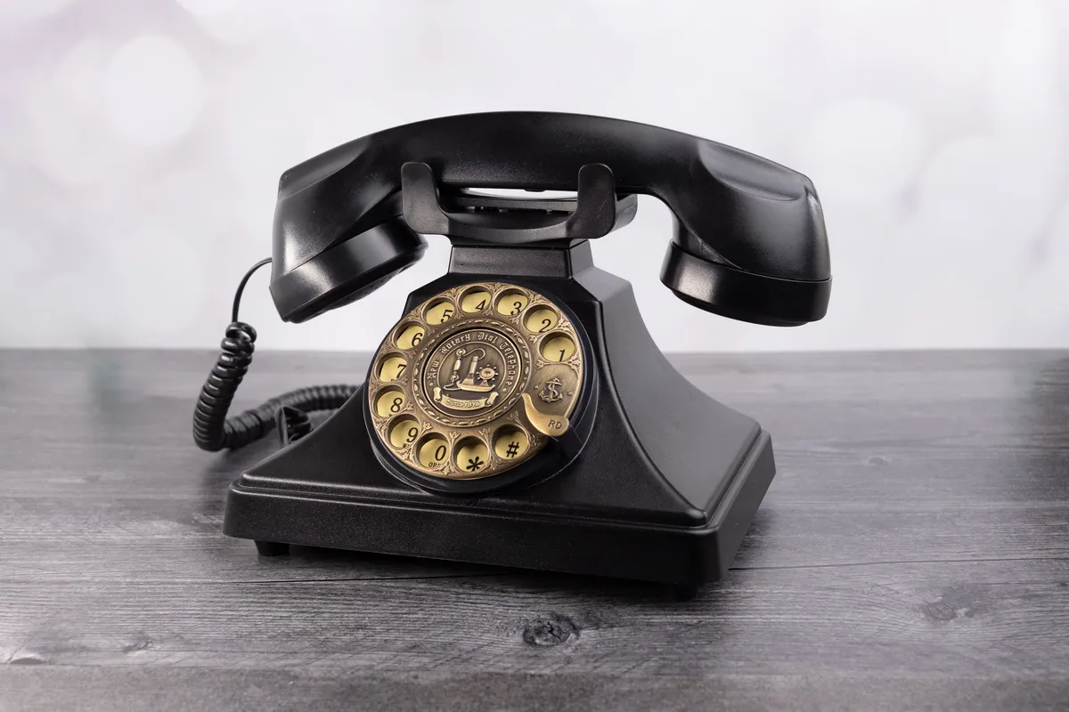 Black vintage rotary phone on table