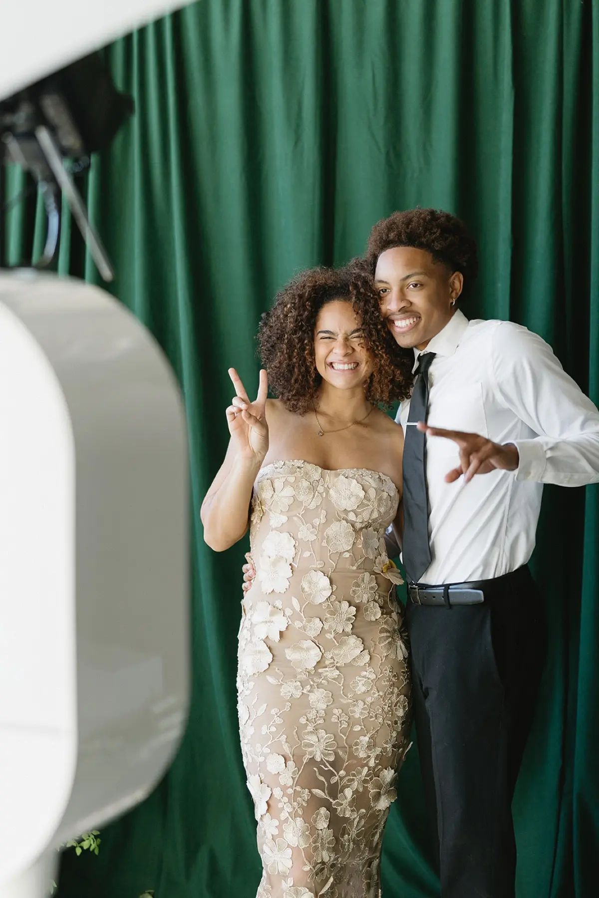 Velour floral photo booth with elegant green botanical arrangement in Los Angeles
