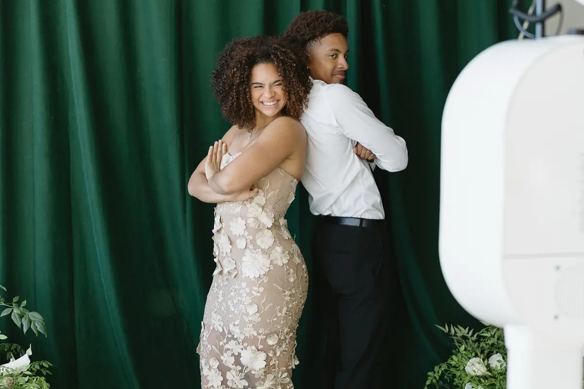 Velour floral green studio photo booth backdrop creating elegant portraits at an outdoor celebration